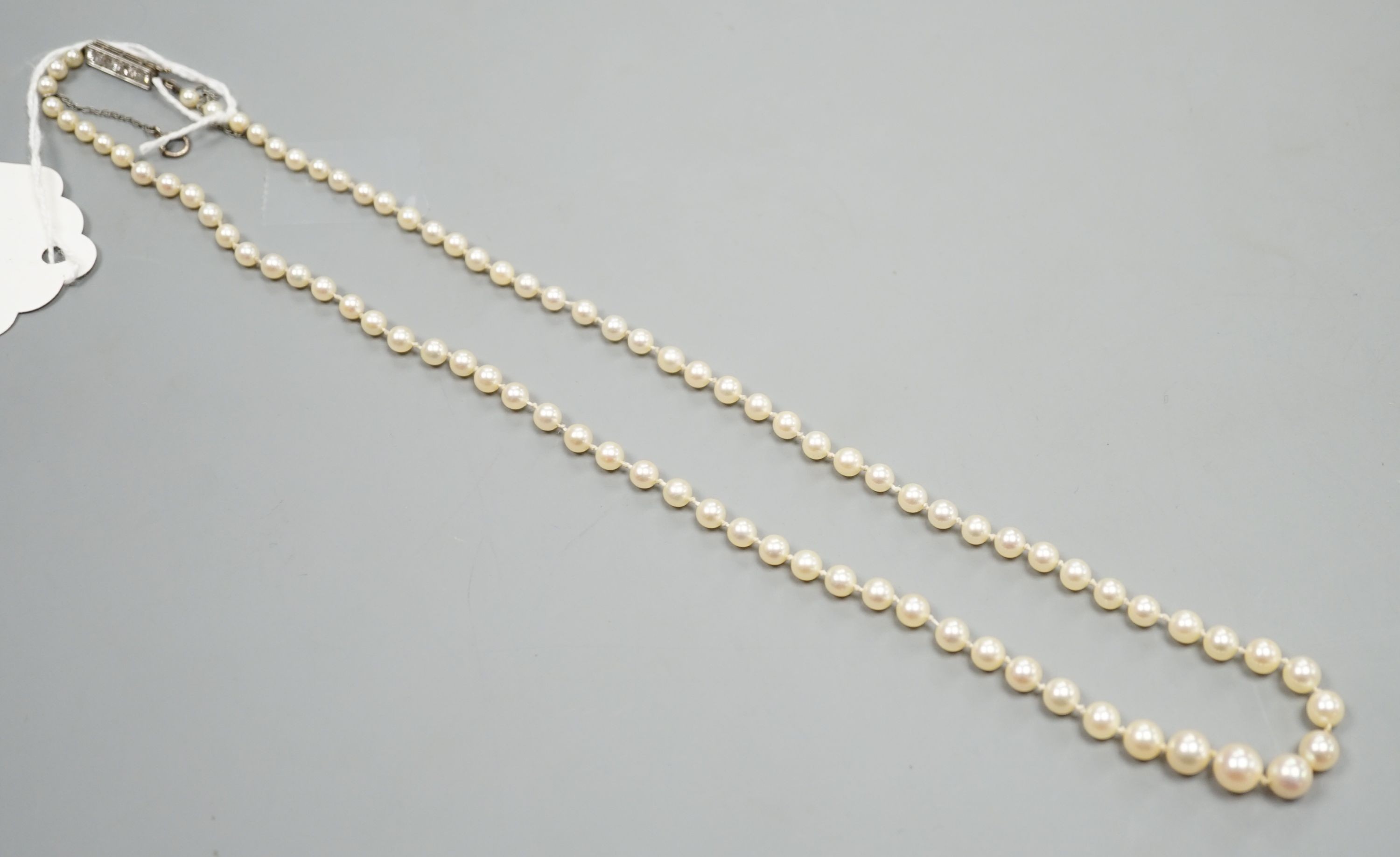 A single strand graduated cultured pearl necklace, with four stone diamond set white metal clasp, 50cm, gross weight 14.4 grams (pearls have not been tested).